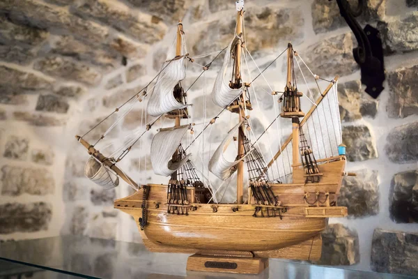 BUDVA, MONTENEGRO - SEPTEMBER 5, 2015: Wooden replica of the old famous vessel "Golden hind" sailfish as ship model in a stone room inside the old town. — Stock Photo, Image