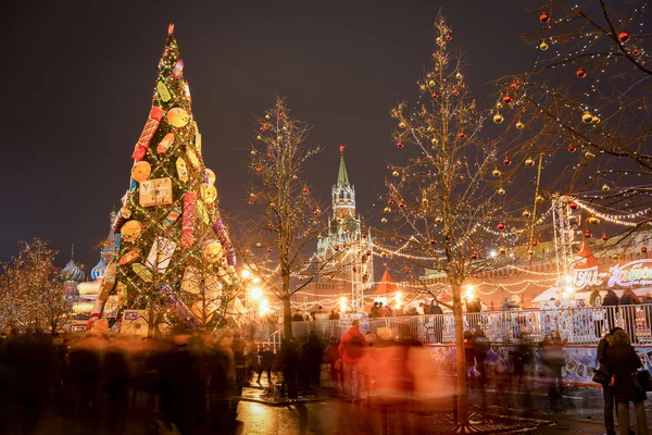 Moskva, Ryssland - 12 December 2015: människor nära skridskobana på nyår rättvis på Röda torget i Moskva i natt. Röda torget är det historiska torget i Moskva. — Stockfoto