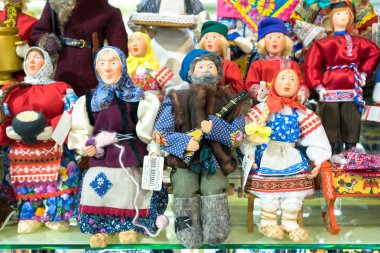 MOSCOW, RUSSIA - DECEMBER 11, 2015: Moscow souvenirs, traditional handmade rag toys puppets dolls in folk costumes (traditional Russian clothing) in Central Children's Store on Lubyanka