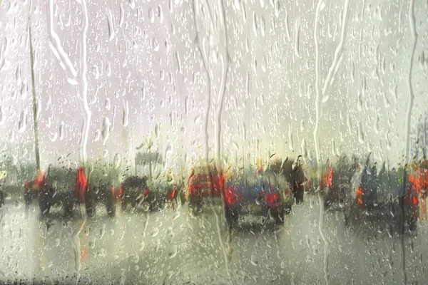 Vue sur la route à travers la fenêtre de la voiture avec gouttes de pluie, Conduite sous la pluie. — Photo