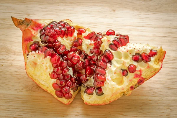 Delicious pomegranate fruit on wooden background — Stock Photo, Image