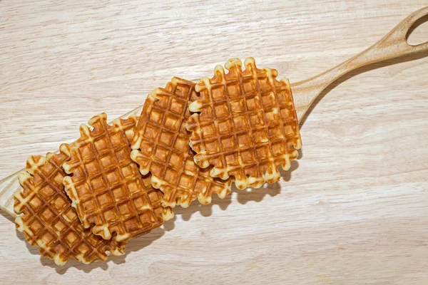 waffles for breakfast on wooden cutting board with curved edges and copy space