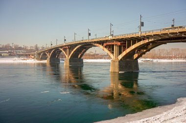 Old reinforced concrete Glazkovsky bridge built in 1931-1936 years across the river Angara in town Irkutsk, Russia, Siberia. River Angara never covered with ice, even in the most severe frosts.