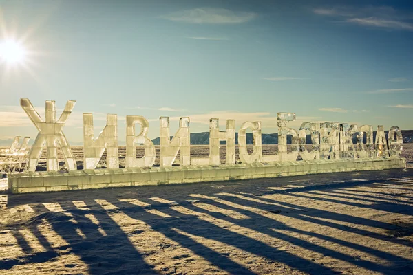 Listvyanka, Russia - 17 February, 2016: 30-meter ice inscription "Live at the Lake Baikal " on the lakeside in Listvyanka. Letters have a height of 3 meters. Made by ice sculptor Andrey Pylyuh. — Stock Photo, Image