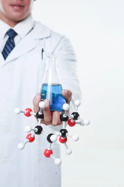 一个化学家 手里拿着一个瓶子和化学矩阵 — 图库照片