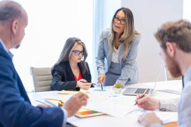 Ofis çalışanı ekibiyle toplantı yapıyor.