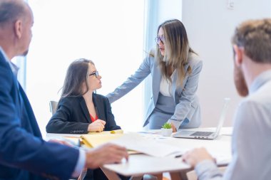 Ofis çalışanı ekibiyle toplantı yapıyor.