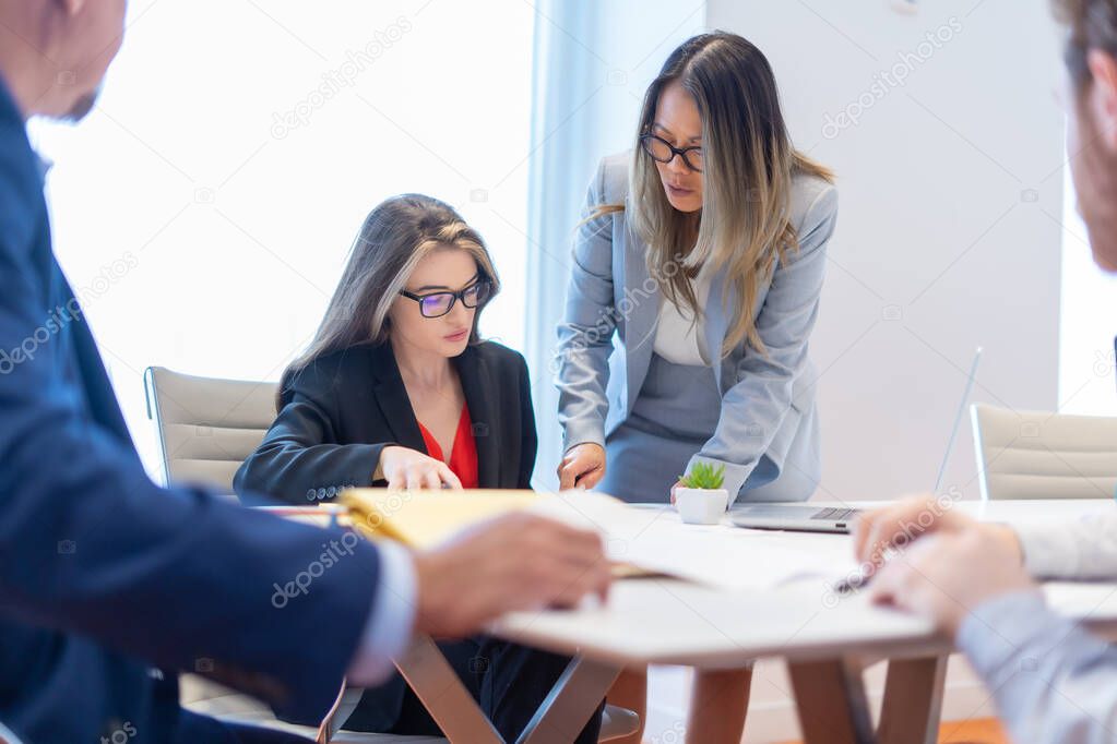 Office employee having a meeting with their team