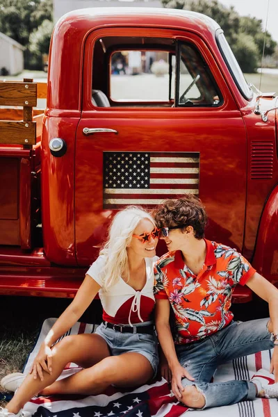 Couple in a vintage red truck