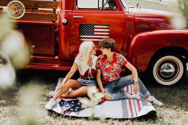 Couple in a vintage red truck