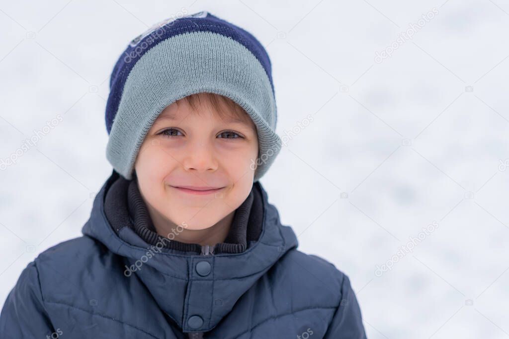 Winter portrait of little boy on a freezing day. Winter fun, kid winter playing -cute boy has a fun in snow