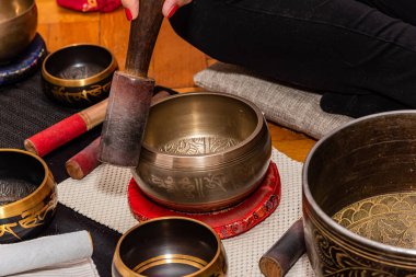 Tibet Şan Kâseleri olarak da bilinen şarkı söyleyen bir kadın, Himalaya kâseleri. Tibet Şarkı Kaseleri Tedavisi. Tibet ses masajı.