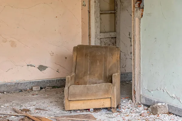 Room in an abandoned house with armchair