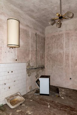 Abandoned house with boiler, stove, chandelier and sink