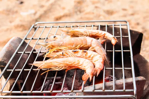 Langostinos frescos a la parrilla sobre mariscos en llamas —  Fotos de Stock