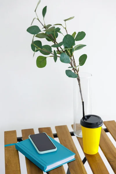 Wooden Table Background White Wall Vase Eucalyptus Branch Yellow Paper — Stock Photo, Image