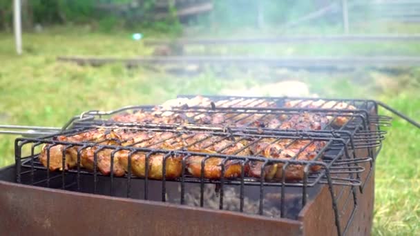 Woman grilling meat sausages outdoor — Stock Video