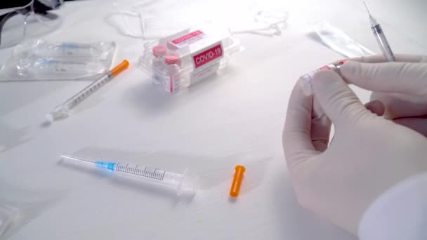 Ο γιατρός του κλειστού θαλάμου γεμίζει τη σύριγγα με το εμβόλιο του κορωναϊού από τη φύσιγγα. Έννοια της θεραπείας της λοίμωξης από τον ιό Coronavirus, εμβολιασμός COVID-19 — Αρχείο Βίντεο