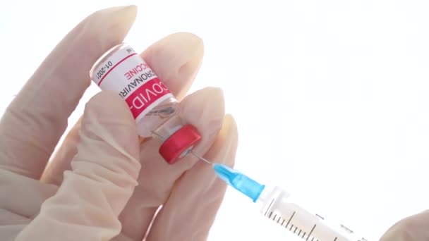 Gros plan médecin remplit la seringue avec le vaccin coronavirus de l'ampoule. Concept de traitement de l'infection par le coronavirus, vaccination COVID-19. 4k — Video