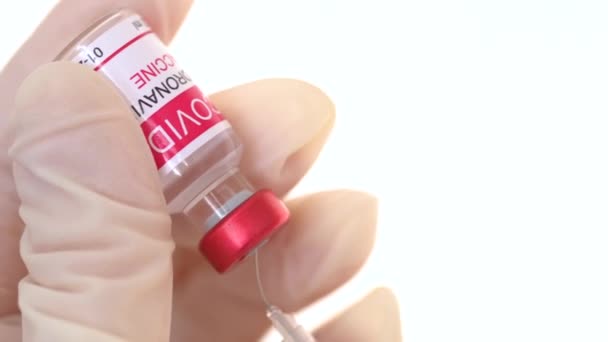 Closeup læge fylder sprøjten med coronavirus vaccinen fra ampullen. Begrebet behandling af coronavirusinfektion, COVID- 19 vaccination. 4k – Stock-video