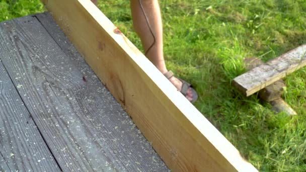 Close up woodworker hands working with electric planer on wooden plank — Stock Video