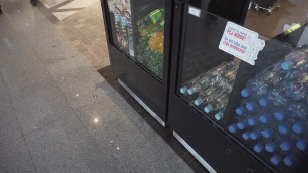 Soft drinks and water bottles in a show-case in front of duty-free shop in Copernicus Airport Wroclaw - Pan, 4K — Stock Video