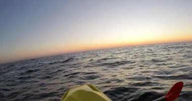 Kayaking in the sea at sunrise - POV, Dutch angle, Wide, DCI 4K