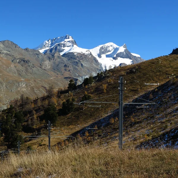 Mountains and power poles of the  Gornergrat train — Stock Photo, Image