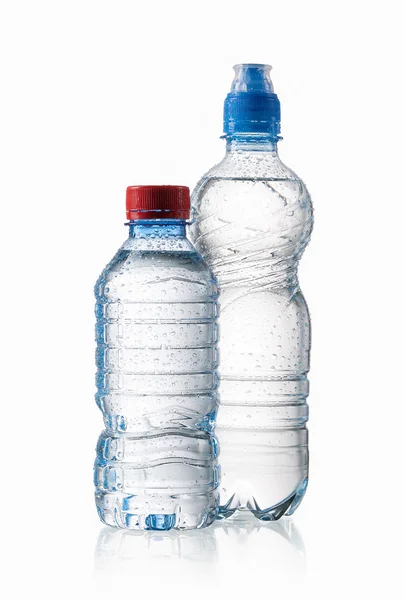 Acqua. Piccole bottiglie d'acqua di plastica con gocce d'acqua su bac bianco — Foto Stock