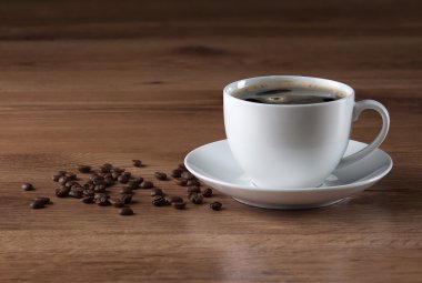 Kahve fincanı ve ahşap doku fasulye