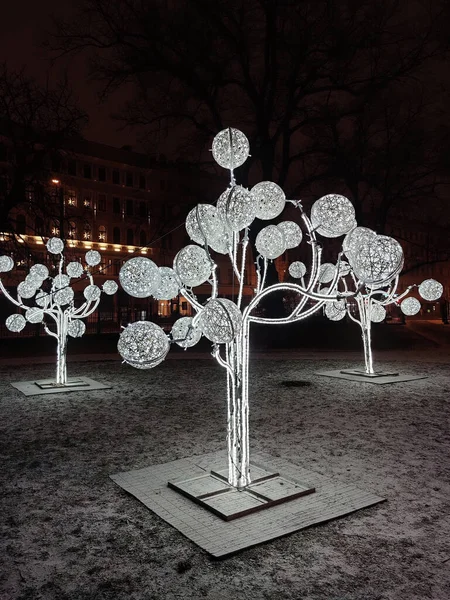 Public Christmas lighting. Light performance in the public park. Street adornment.