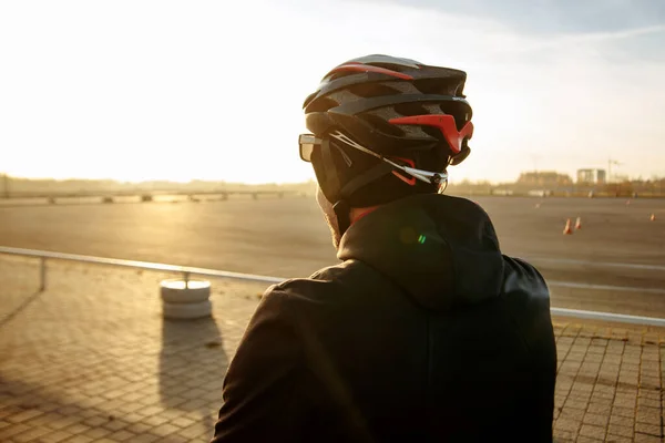 cyclist in black clothes and helmet trains on a bicycle