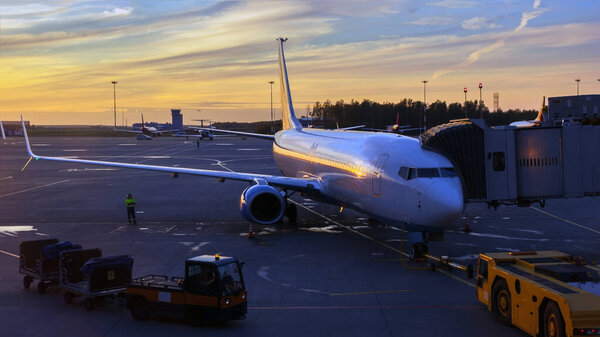 loading the plane at the airport at sunset