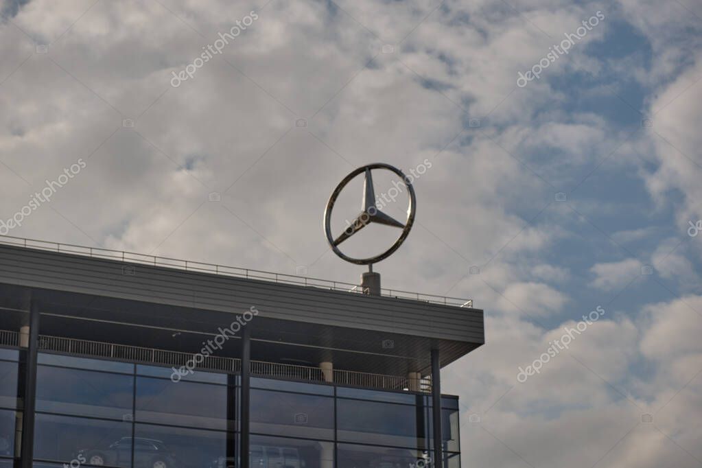 Saint Petersburg, Russia, December 2020: the star, the symbol of Mercedes on the roof of the showroom selling cars