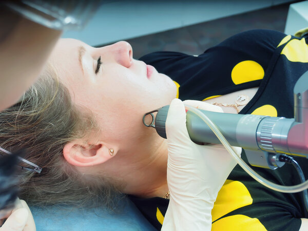 Caucasian woman patient on laser procedure skin resurfacing in aesthetic medicine.
