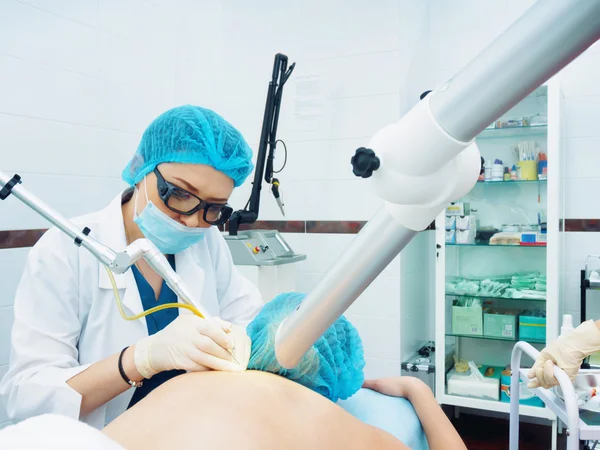 レーザー治療.白人医師が女性患者にプロシージャ皮膚母斑の除去を行う — ストック写真