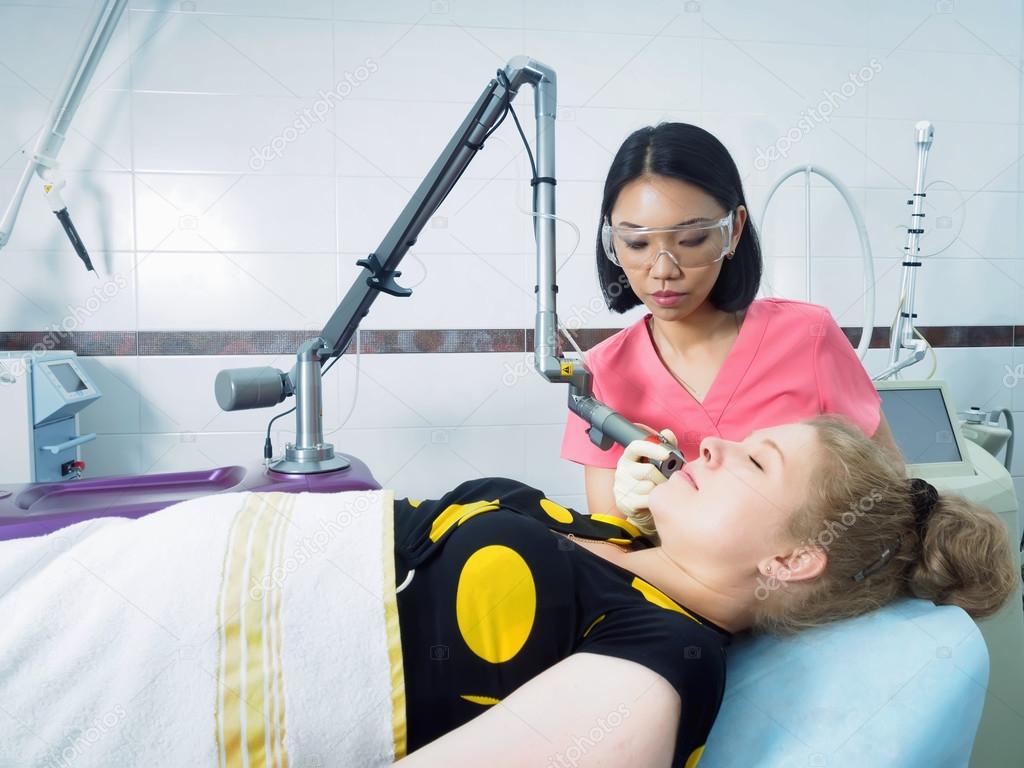 Young asian doctor woman making to patient laser skin resurfacing in aesthetic medicine