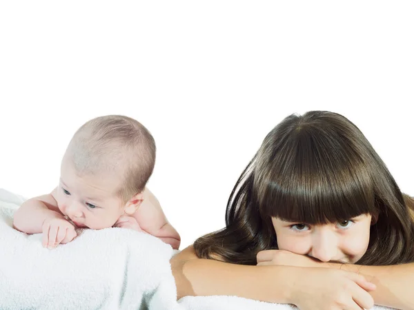 Caucasian child sister and baby brother lying together isolated on white — Stock Photo, Image