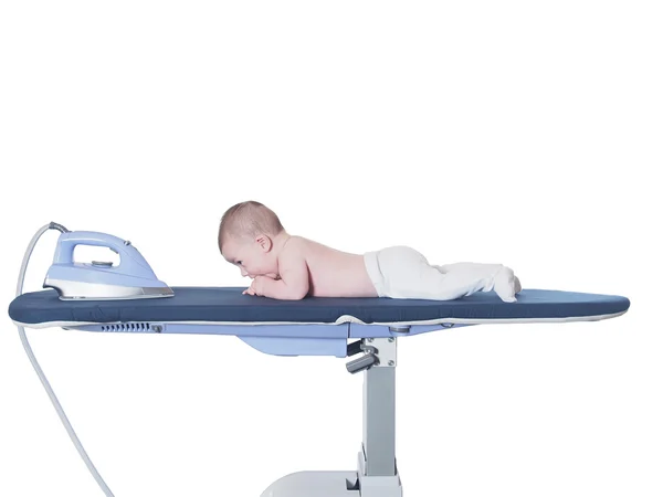 Small caucasian baby boy lying  on ironing system isolated — Stock Photo, Image