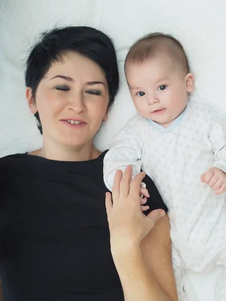 Feliz família caucasiana deitada na cama em casa — Fotografia de Stock