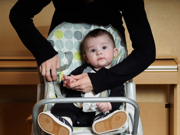 Small caucasian baby boy sitting in child chear — Stock Photo, Image