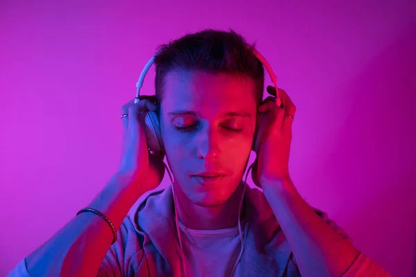 Man Listens to Music With headphones on a Colored Background. Music Poster