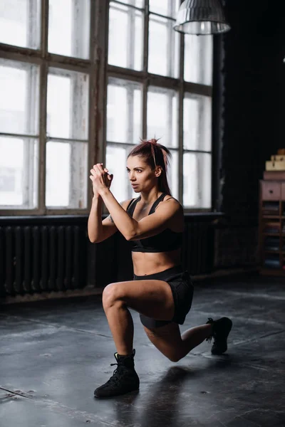 Young girl doing sports in the gym. Atmospheric gym Stock Photo