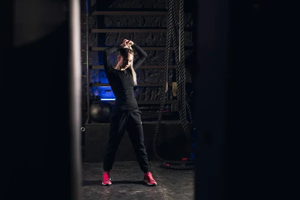 Young girl stands in an atmospheric gym. Sport Royalty Free Stock Photos