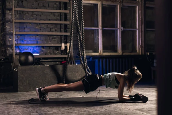 Young girl doing sports in the gym. Atmospheric gym Stock Picture