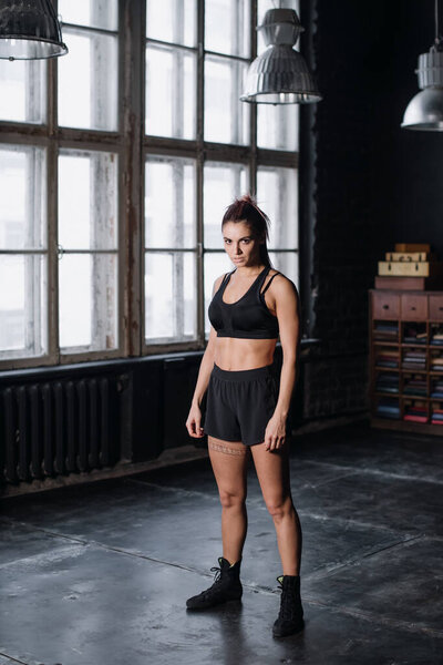 Young girl doing sports in the gym. Atmospheric gym