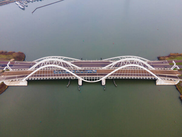 Aerial drone video of the Enneus Heermabrug in Amsterdam, The Netherlands going to Ijburg and Steigereiland Amsterdam Oost east.