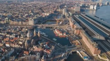 Amsterdam Merkez Havayolları zaman göstergesi, Amsterdam 'daki şehir merkezi ve Lj nehri, Hollanda feribotları ve toplu taşıma araçları insansız hava aracı görüntüsü üzerinden uçuyor..