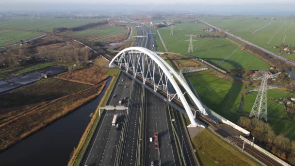 Muiderberg 'deki A1 karayolu üzerindeki Zandhazenbrug kemer köprüsü, Hollanda Havacılık manzarası köprünün altından geçen trafik ve bir tren geçidi. — Stok video