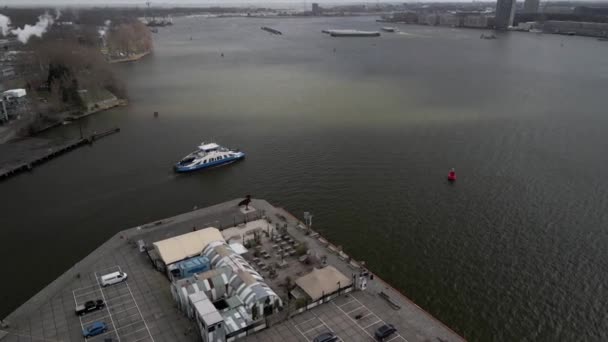 Amsterdam, 14th of March 2021, The Netherlands. GVB public transport ferry crossing the Ij river aerial. Following the ferry. — Stock Video